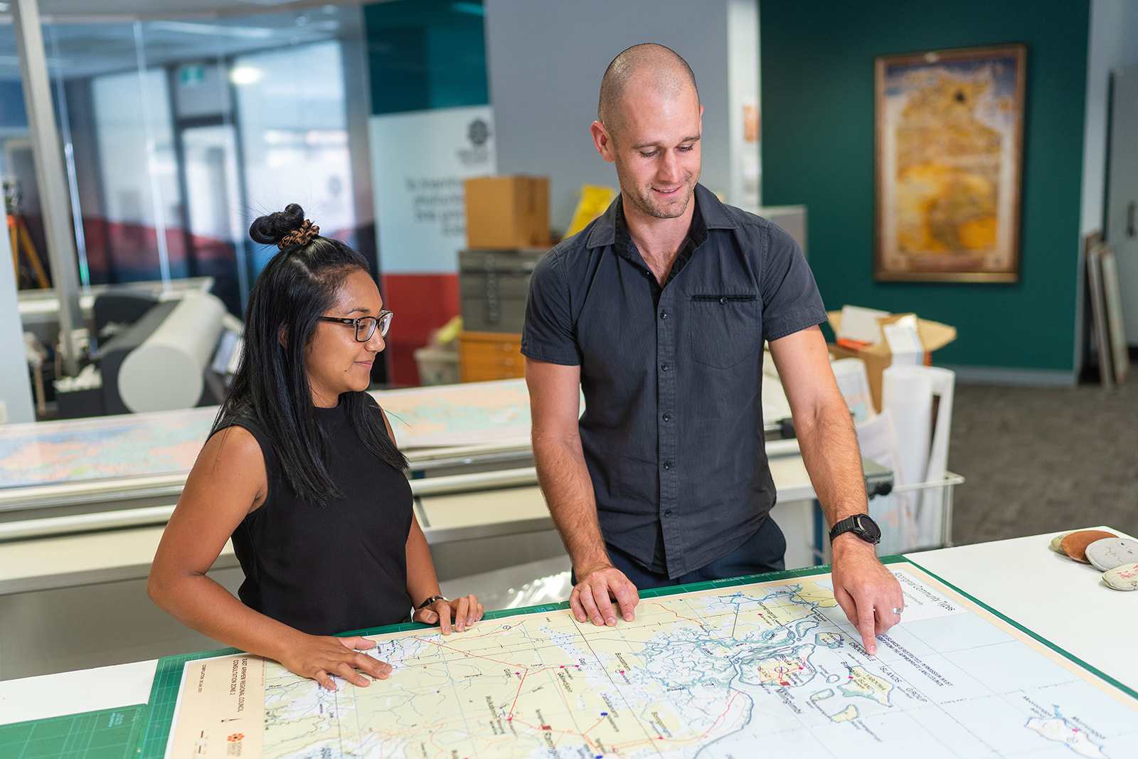 two office workers looking at building plans