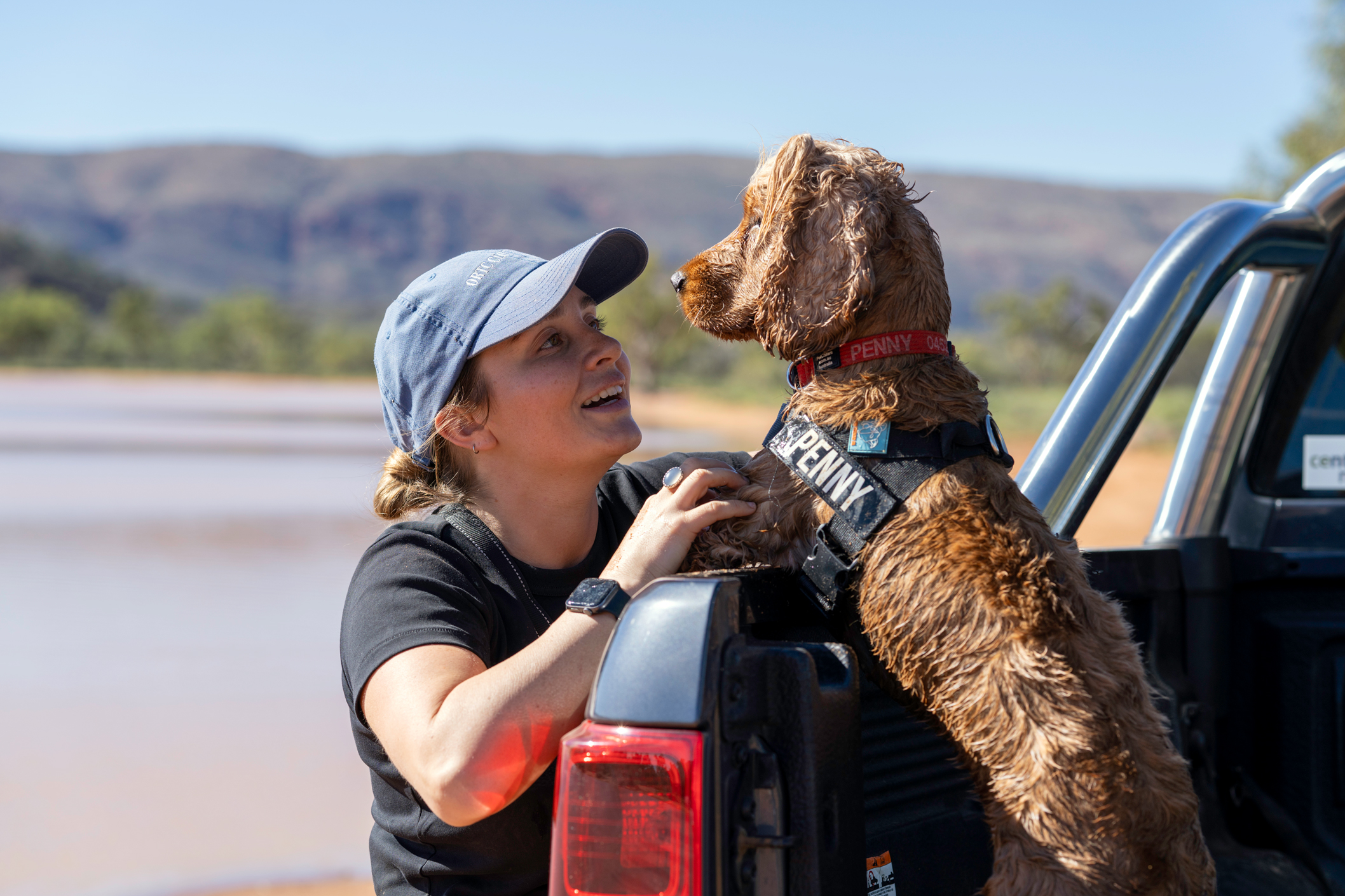 Woman and dog in ute at Claypans in Alice Springs, NT