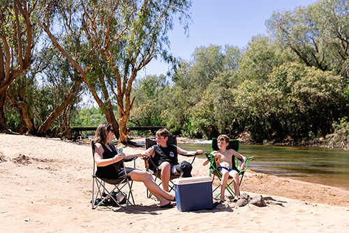Kids sitting next to Katherine river with m