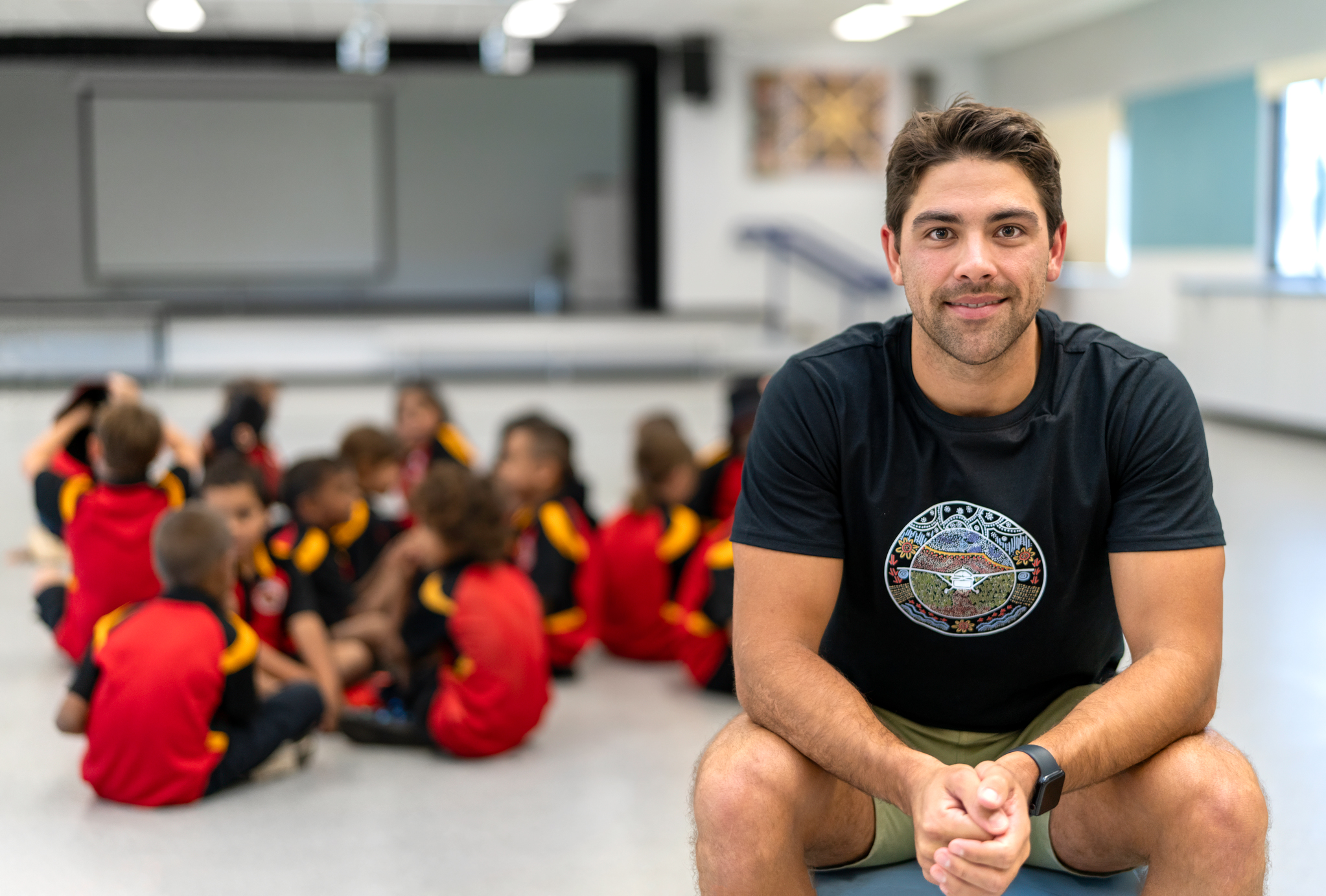 Male Teacher in classroom sitting