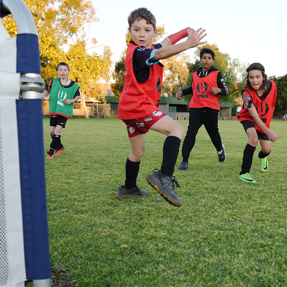 Kids playing soccer square image