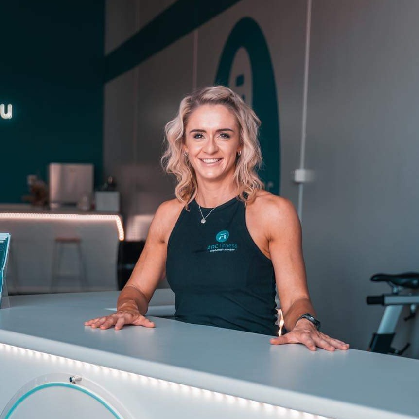 woman smiling behind desk