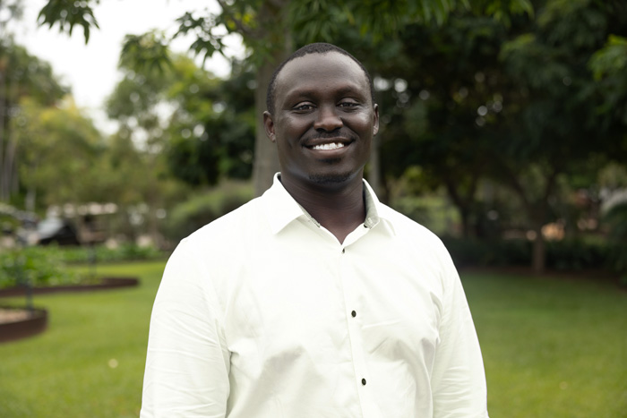 Man in white shirt looking at camera in front of NT Parliament house