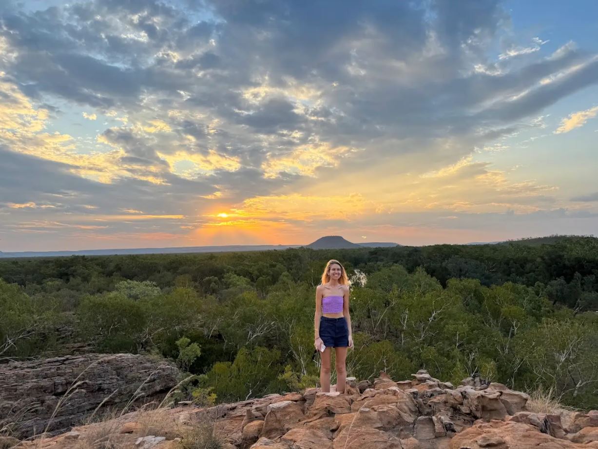 Women standing at sunset