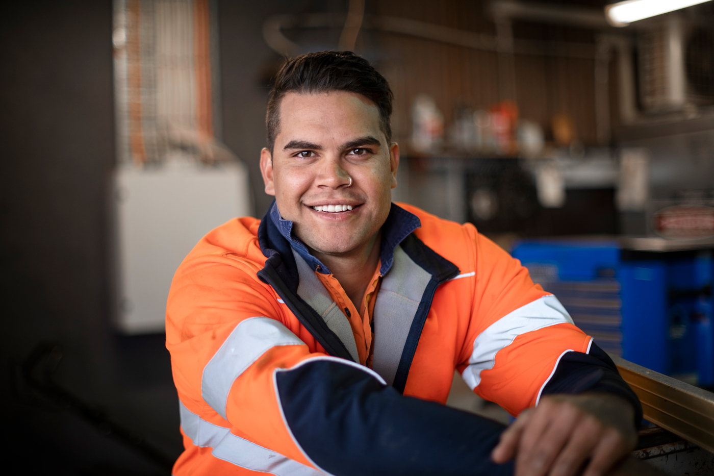 Man wearing engineering outfit looking at camera