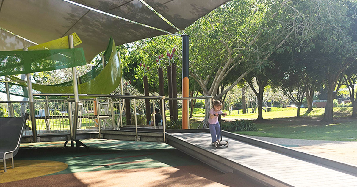 Kid riding scooter at Darwin playground
