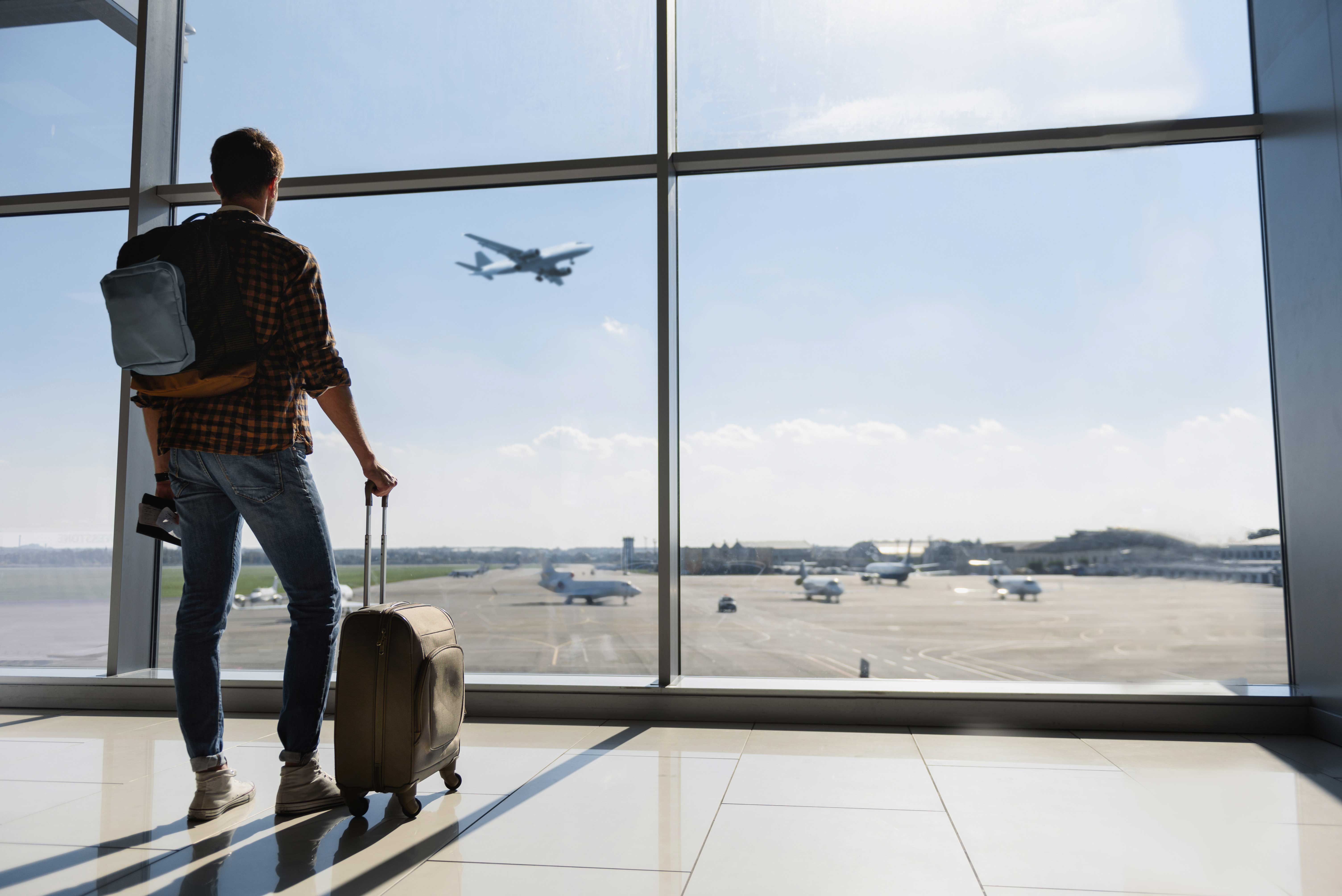 Person looking out at plane flying