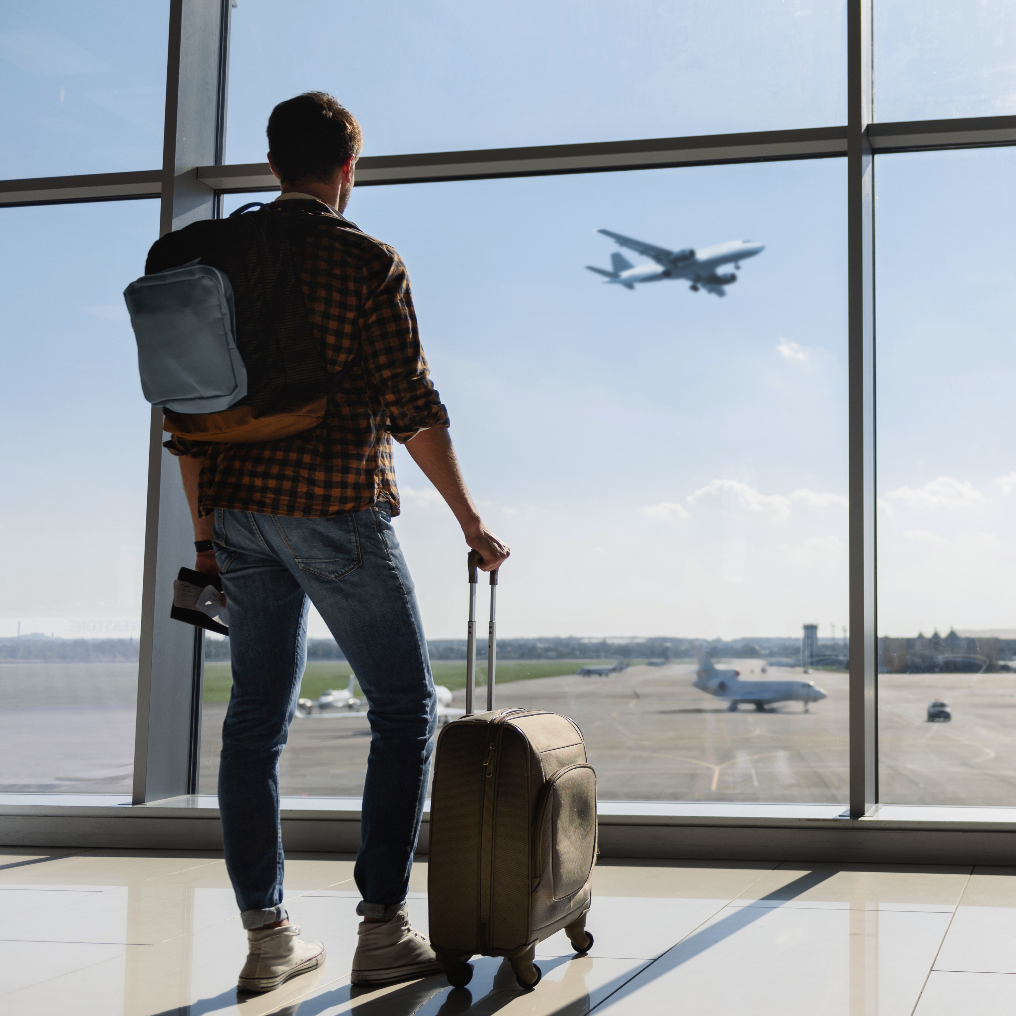 Person looking out at plane flying