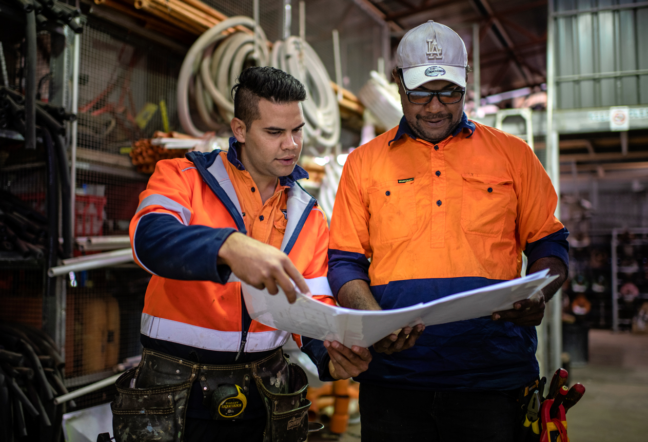 Two engineers looking at plans in the Northern Territory