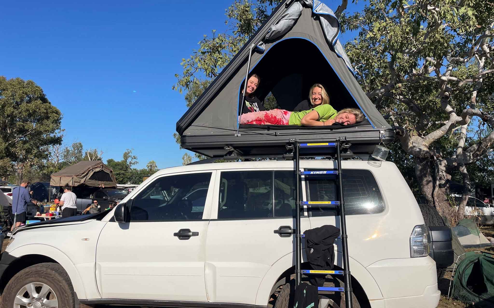 Maddy in a roof top tent with friends