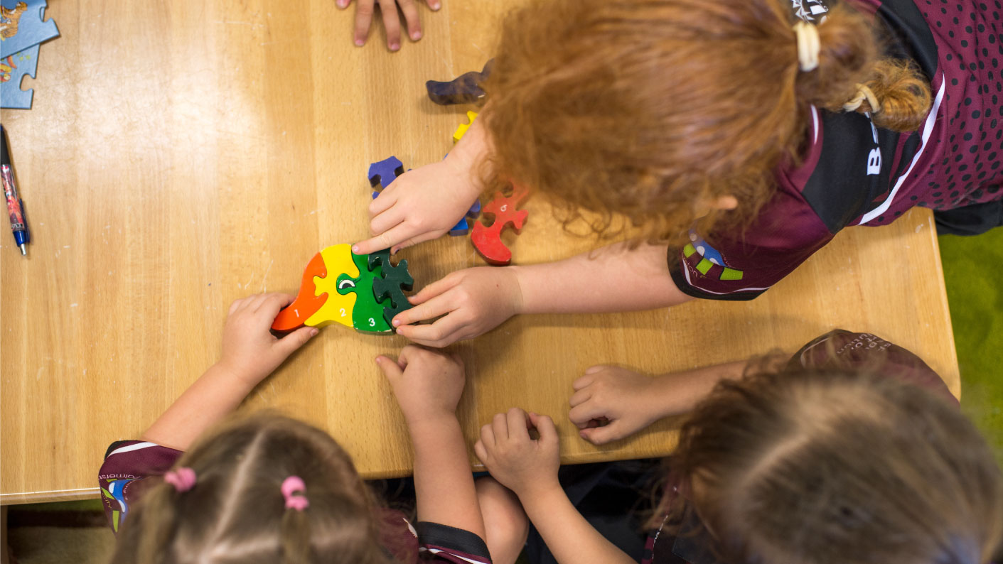 Children doing puzzle at preschool