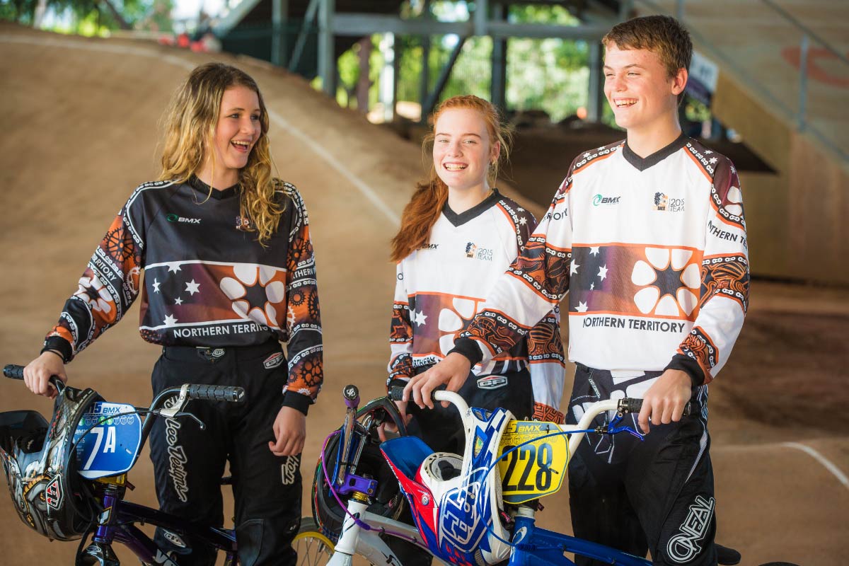 Three youths with BMX bikes at BMX track in Darwin