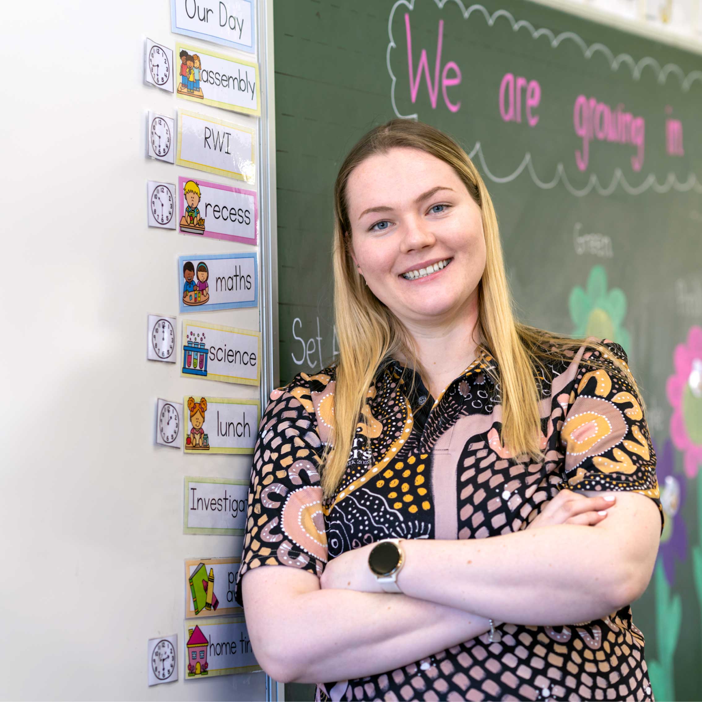 Teacher, Emma Richards, standing in front of classroom whiteboard