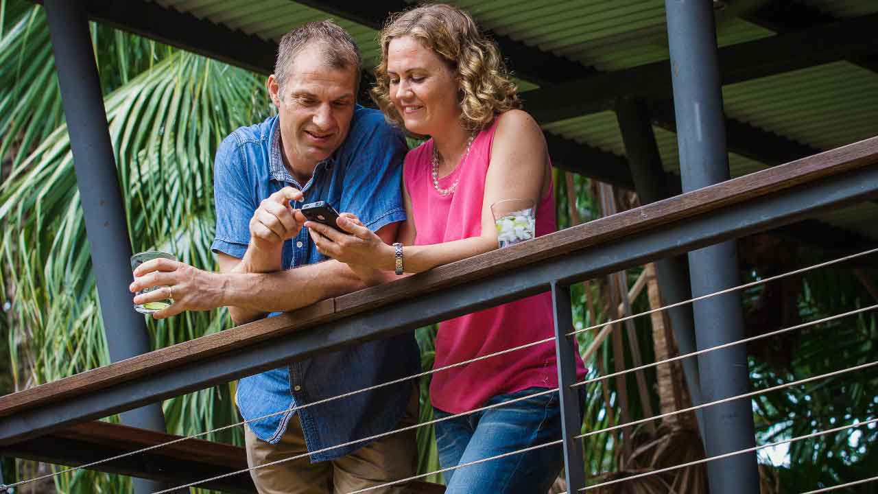 Couple on deck of tropical Darwin home