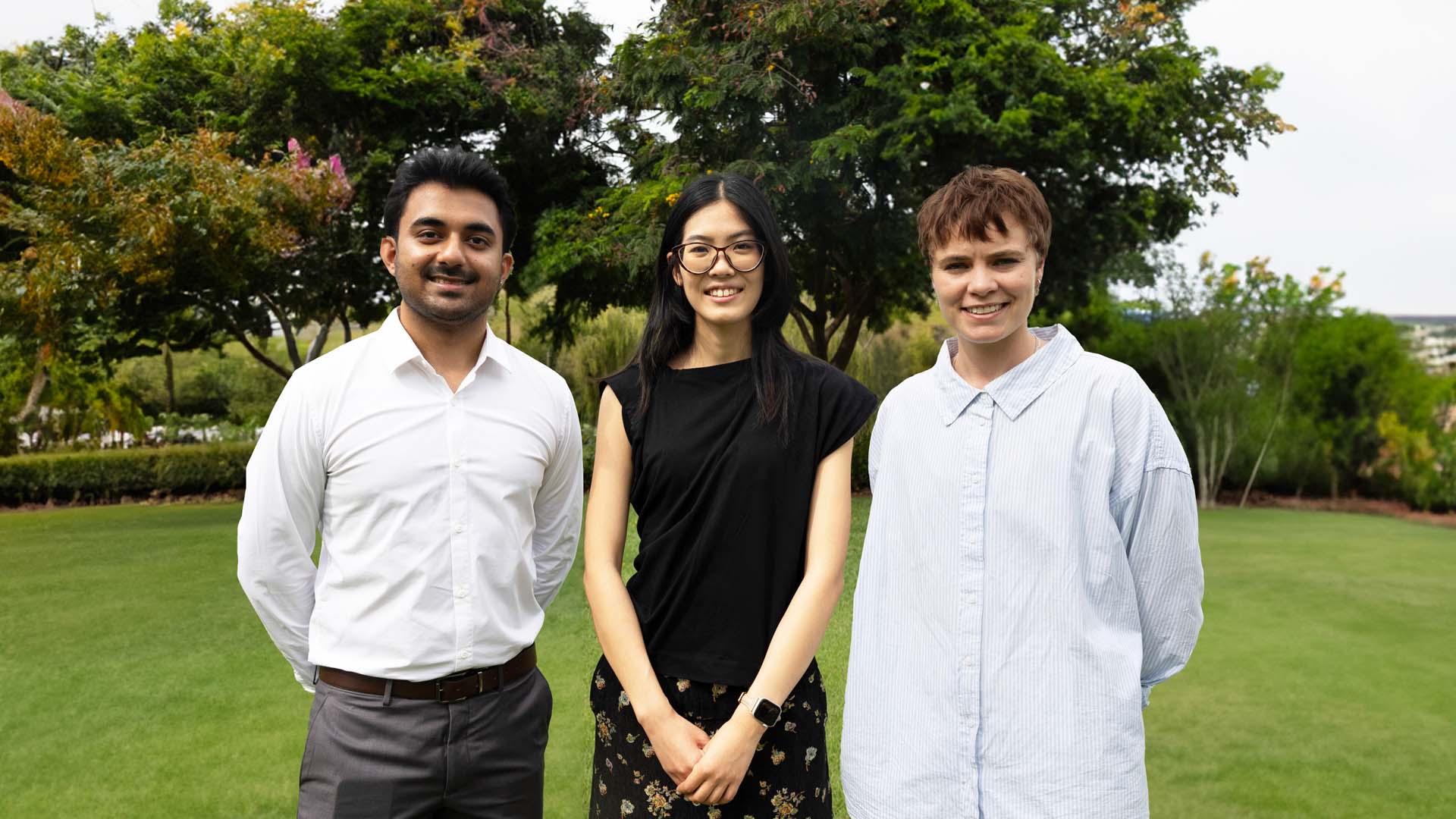 three nothern territory government graduates standing in a garden in darwin