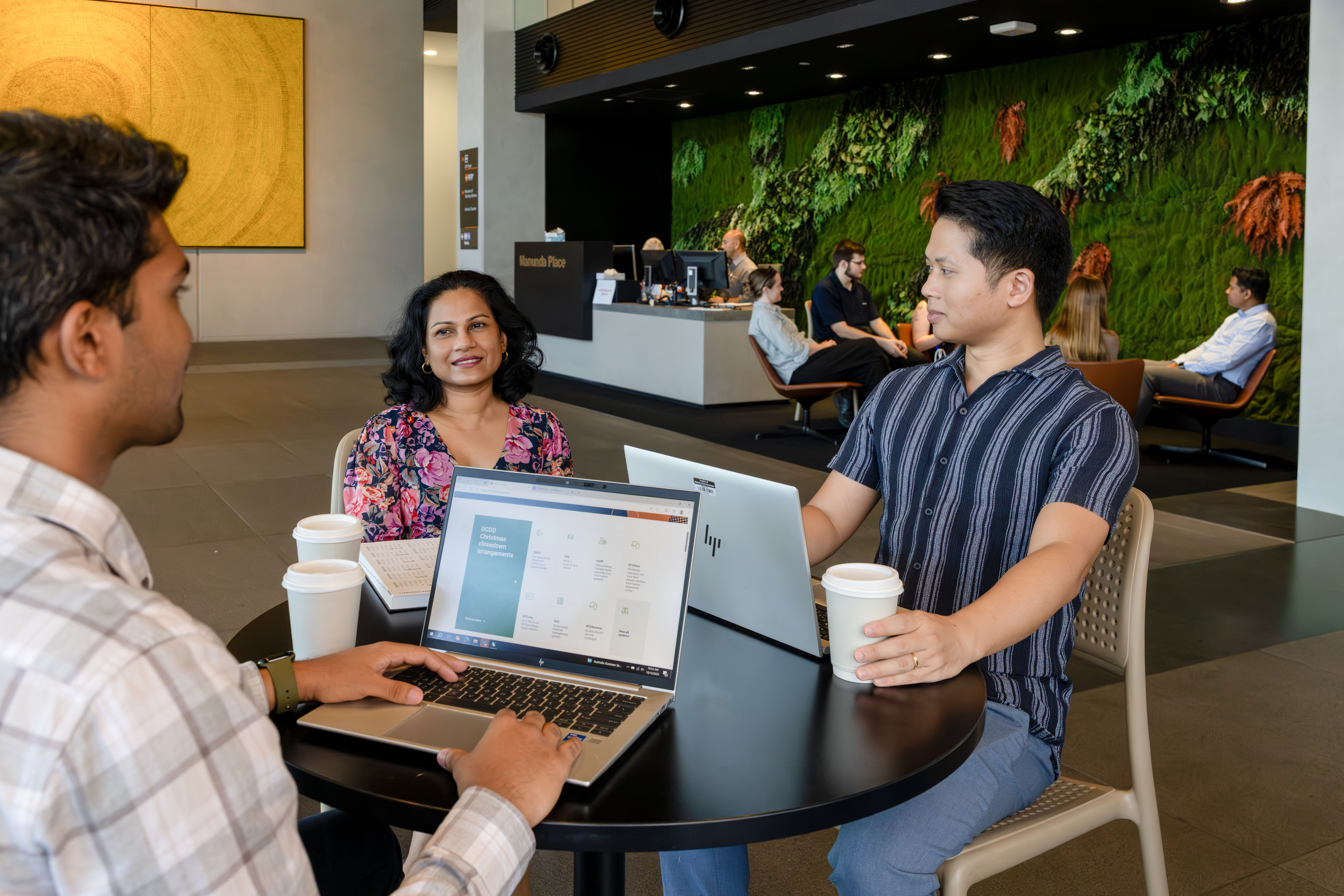 Workers in a meeting with laptop