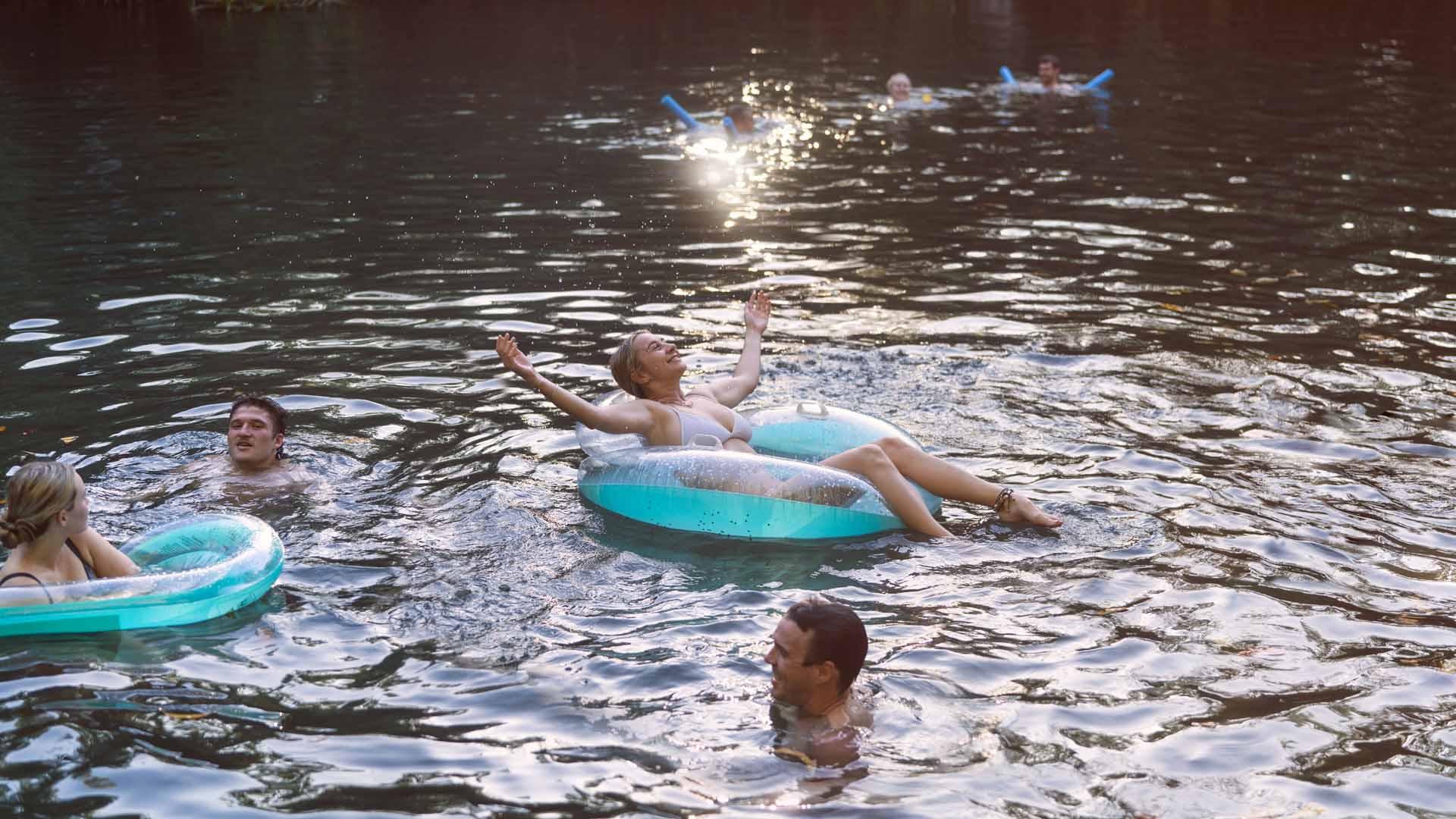 Woman floating in water at Berry Springs