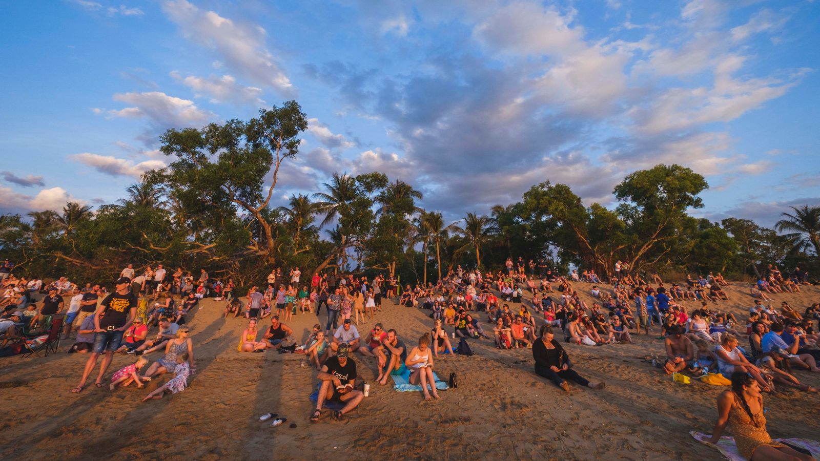 People gathered on the sand at Mindil Beach in Darwin at sunset