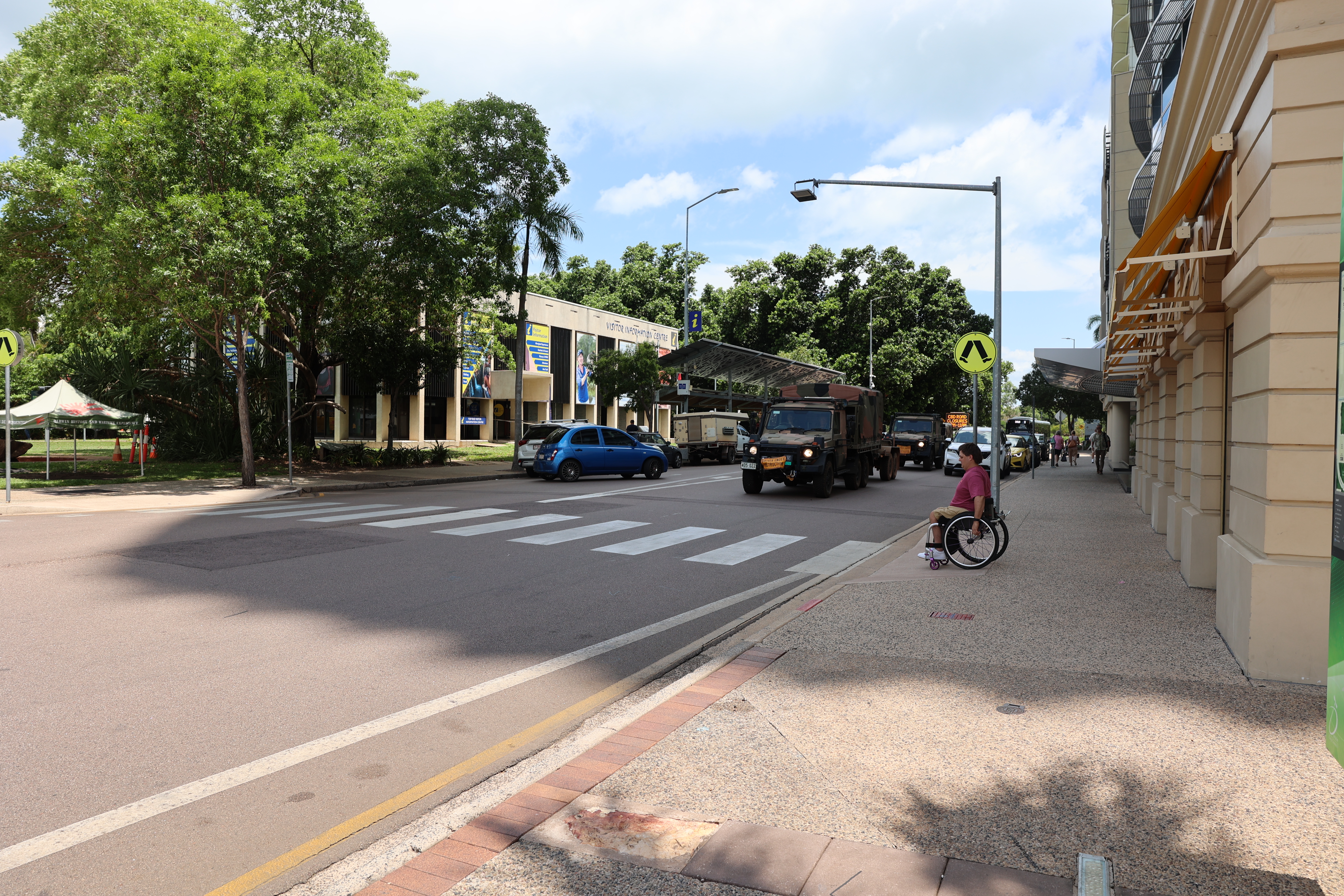 Man in Wheelchair about to use zebra crossing