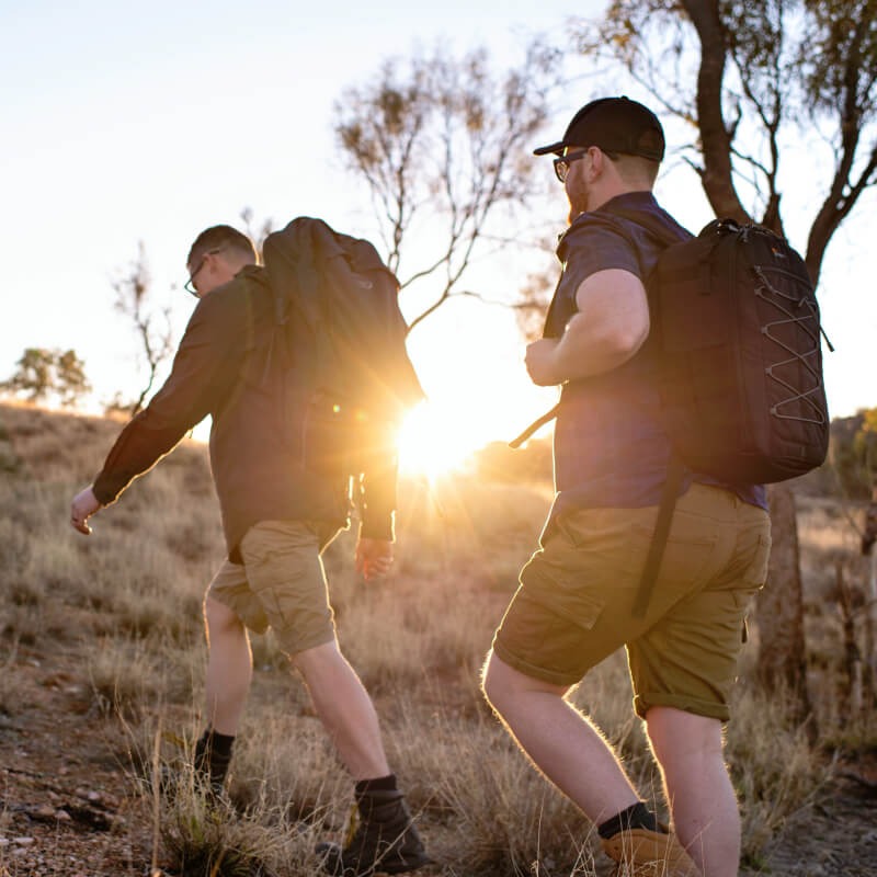 Guys hiking up a hill