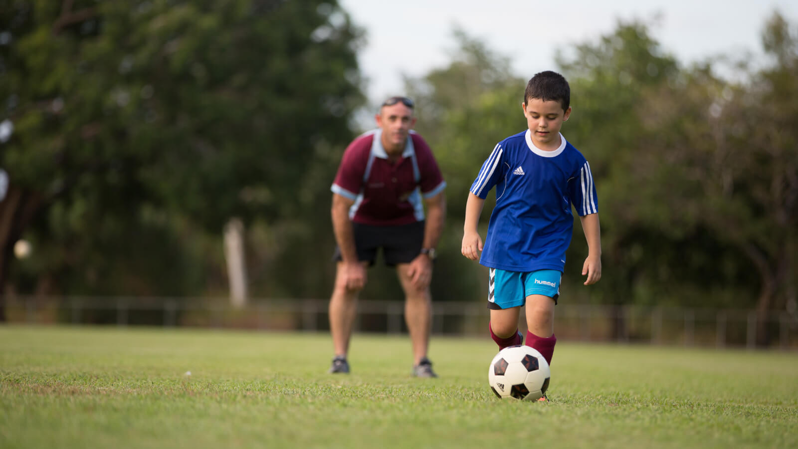 Child kicking a soccer ball  Alice Springs