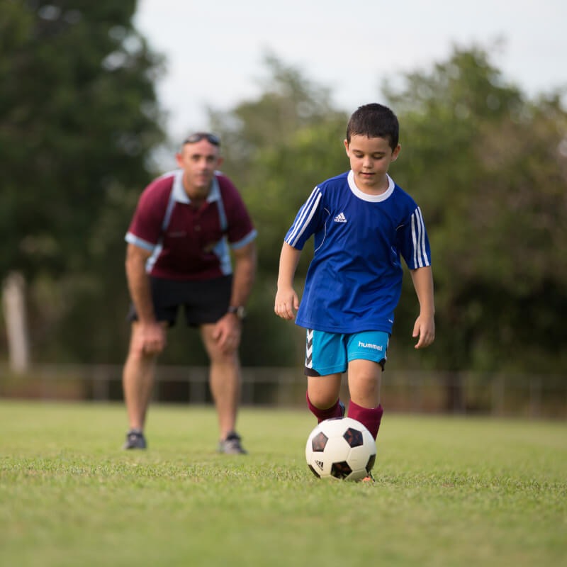 Child kicking a soccer ball