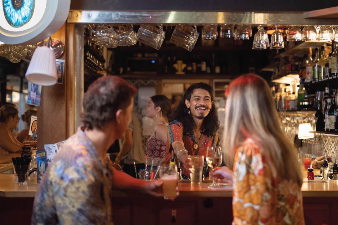 Darwin bar with staff serving a glass of wine
