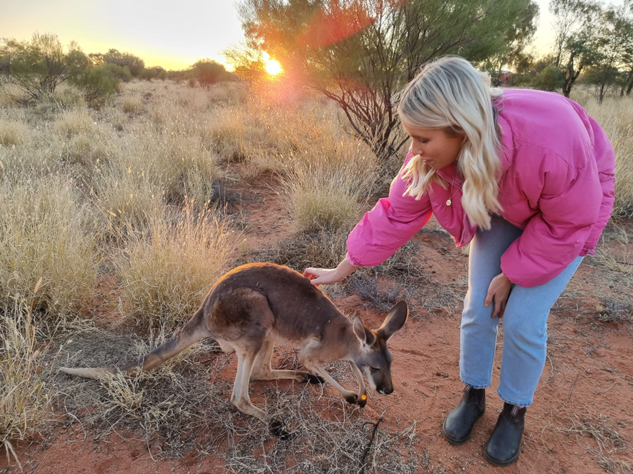 women petting kangaroo