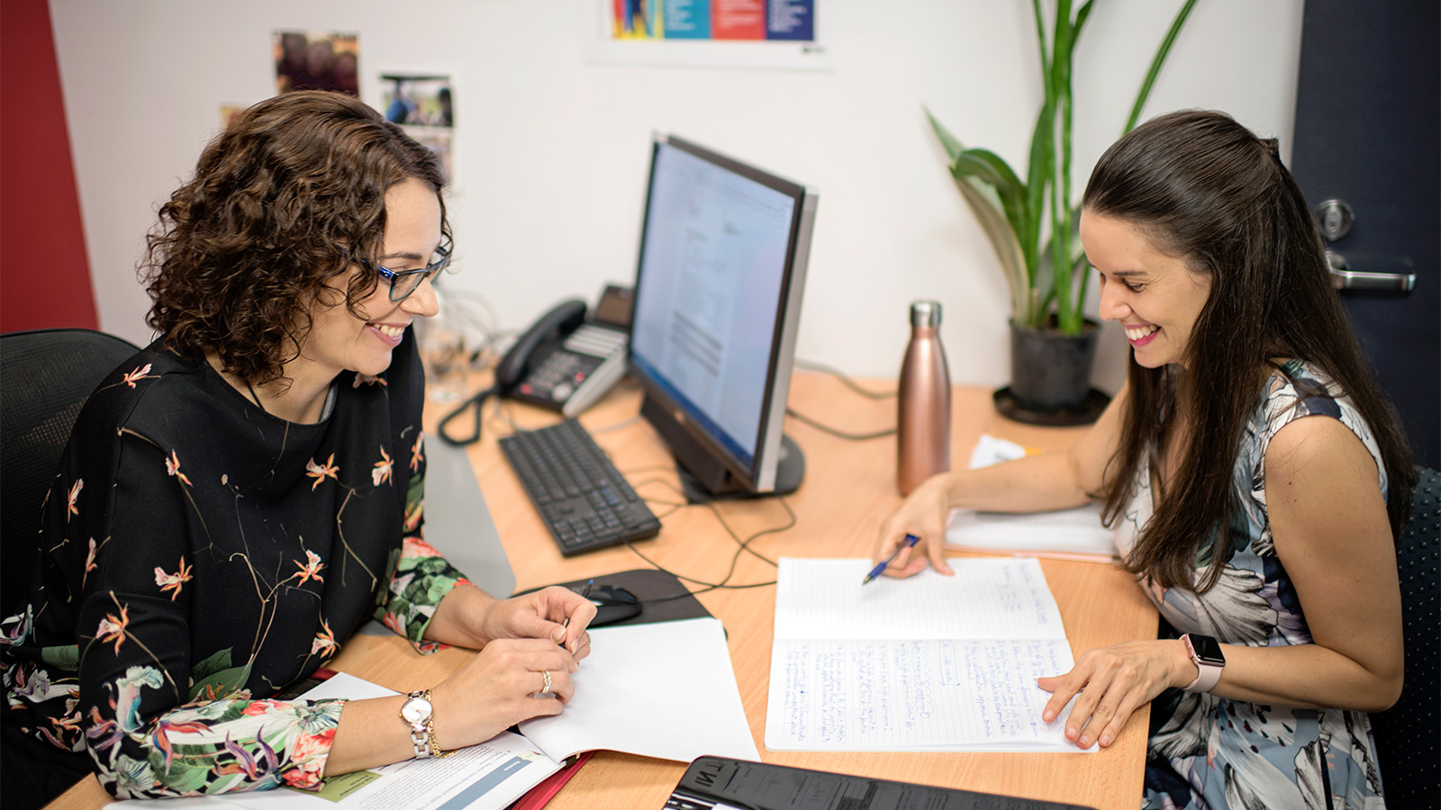 Women discussing paperwork in NT Office