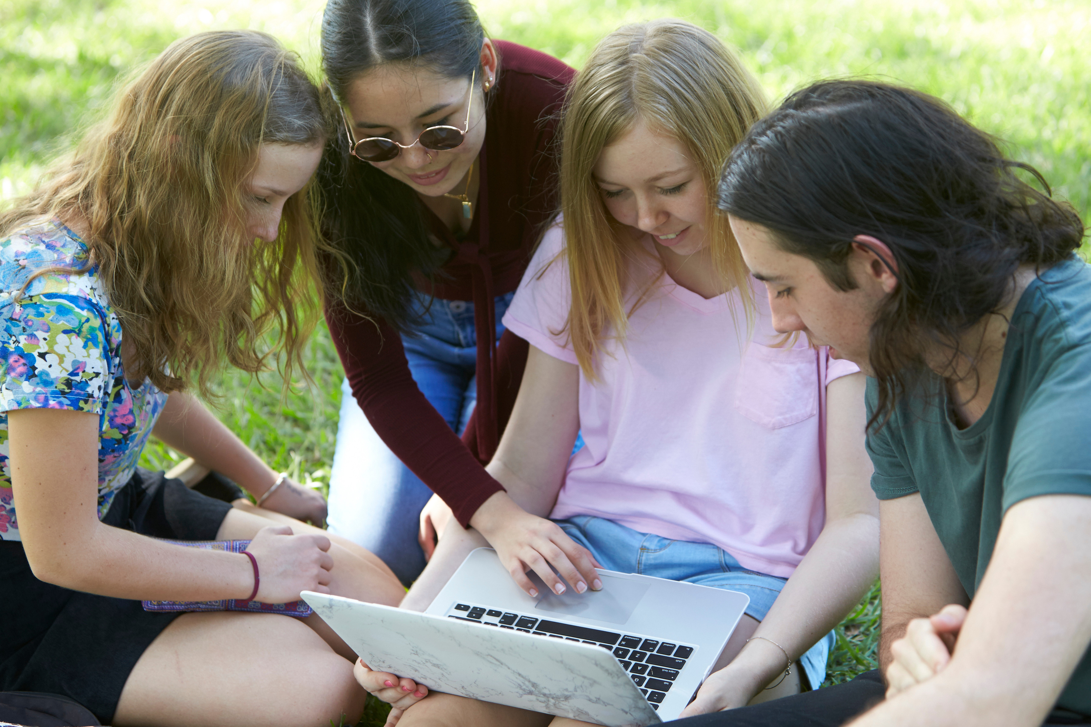 Teenagers look at computer