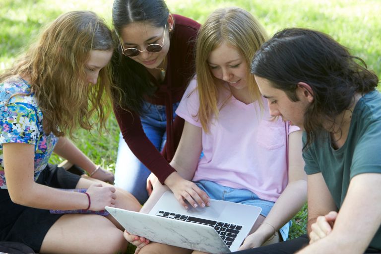 Teenagers look at computer