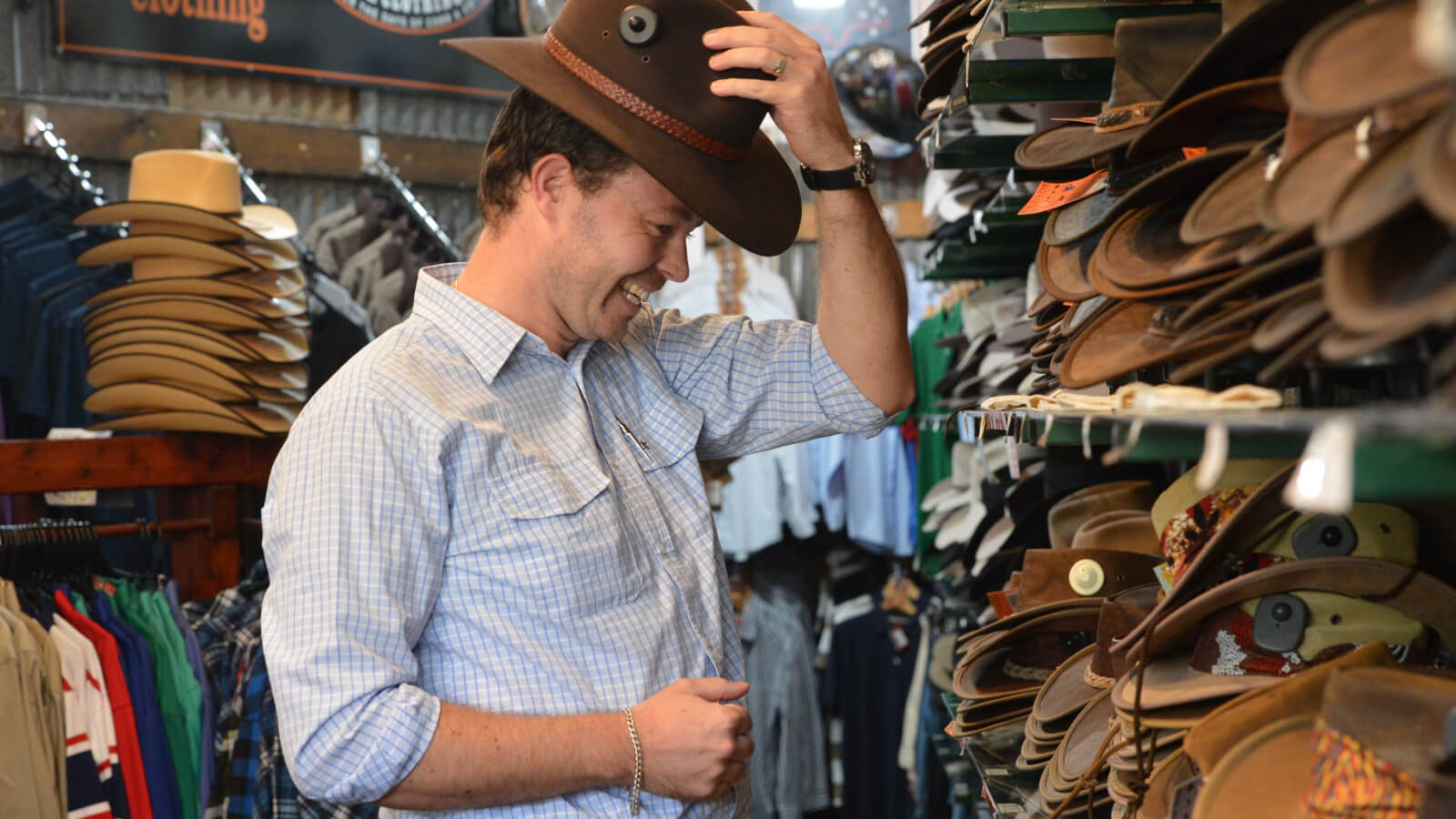 Man trying on hats